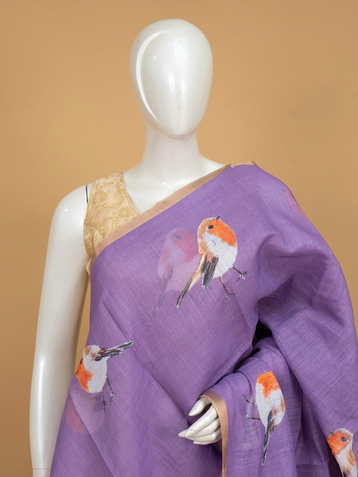 Lavender linen cotton saree with orange and white robin bird prints and gold zari border