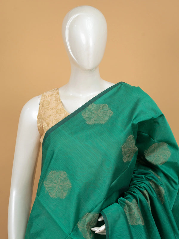 Teal green silk cotton saree with cream floral buttas and contrast purple woven border and pallu
