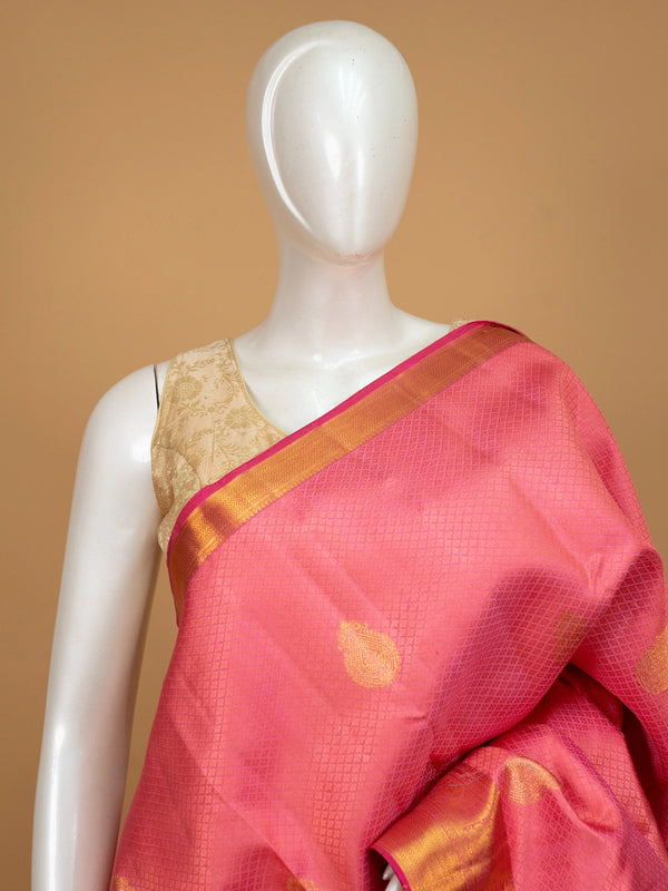 Coral pink pure Kanchipuram silk saree with gold zari buttas and contrast zari border