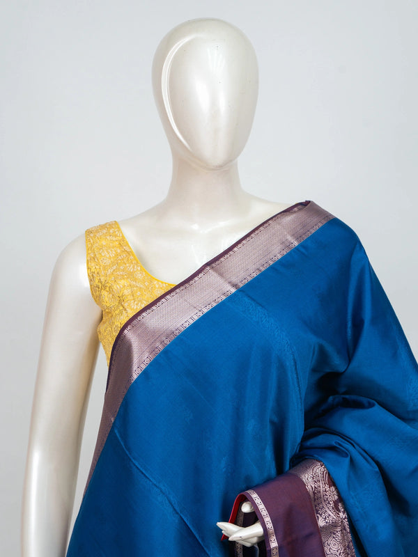Peacock blue semi silk saree with contrast purple border and silver zari pallu