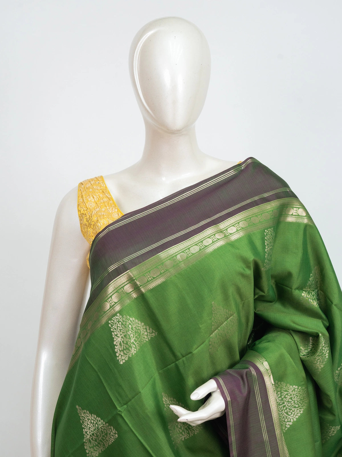 Green Kanchipuram fancy silk saree with contrast mauve zari border and triangular temple zari buttas