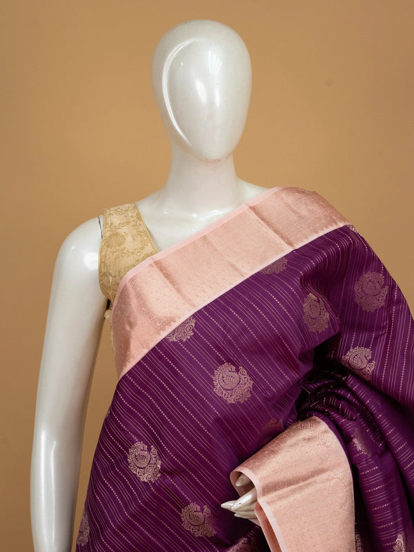 Purple pure Kanchipuram silk saree with peach zari contrast border and paisley zari buttas