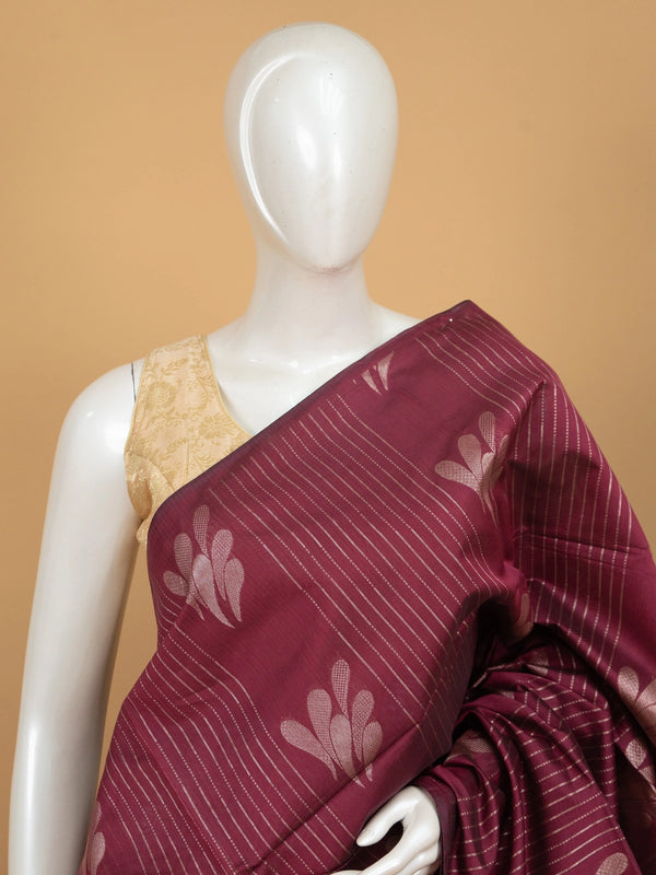 Maroon silk cotton saree with silver zari stripes, leaf motifs and woven scroll border