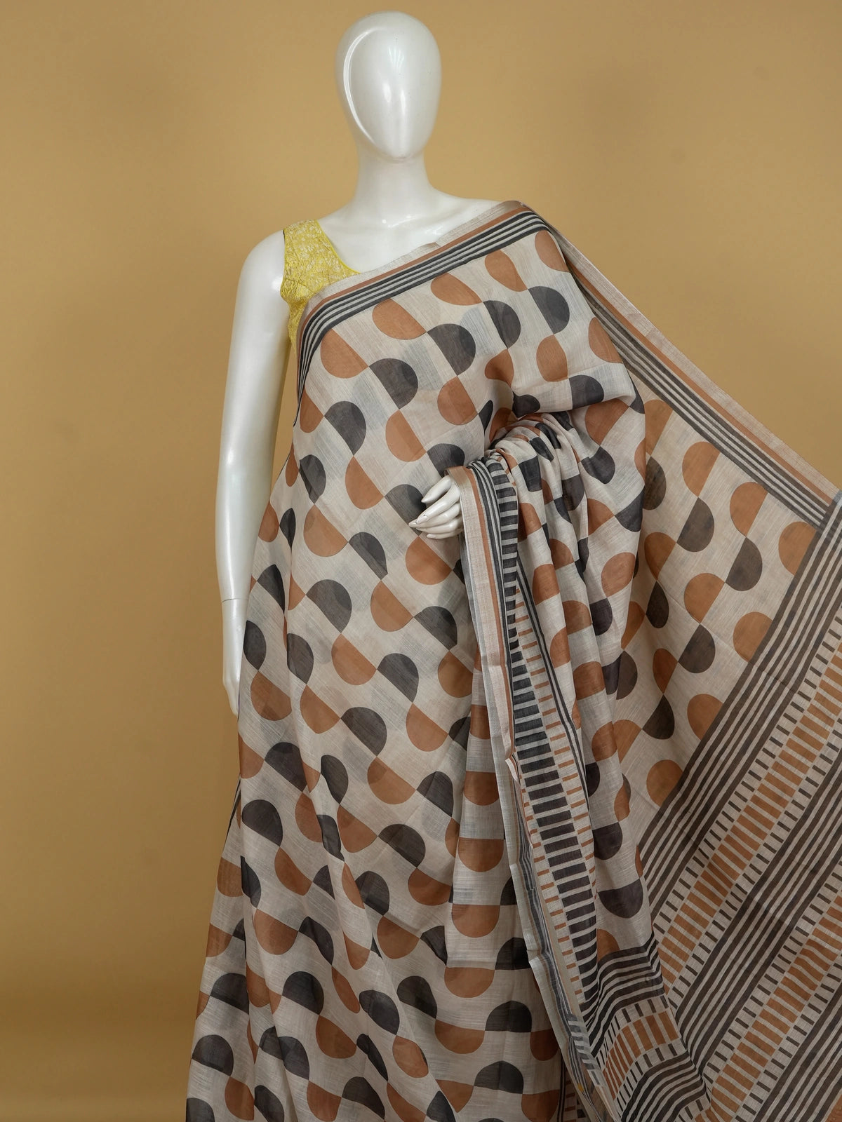 Cream and rust geometric print linen cotton saree with striped border and contrasting blouse