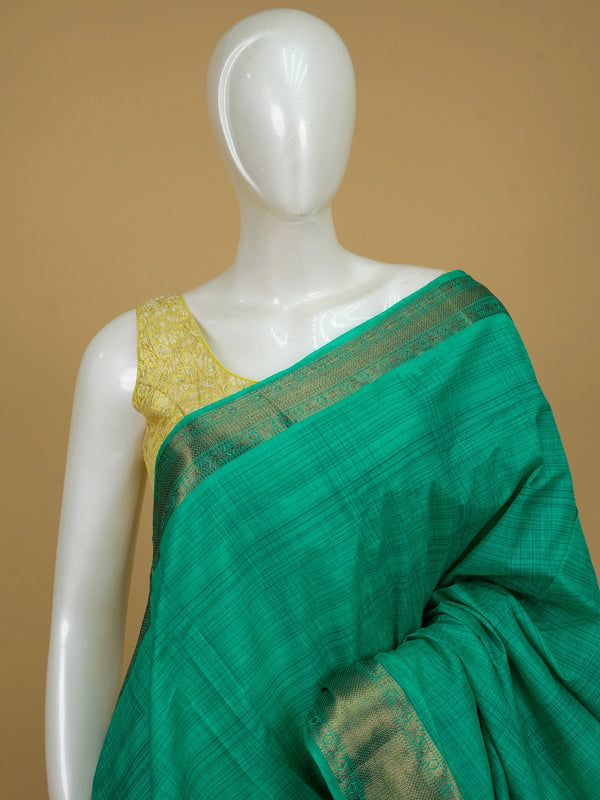 Green semi tussar saree with gold zari border and matching green butta blouse