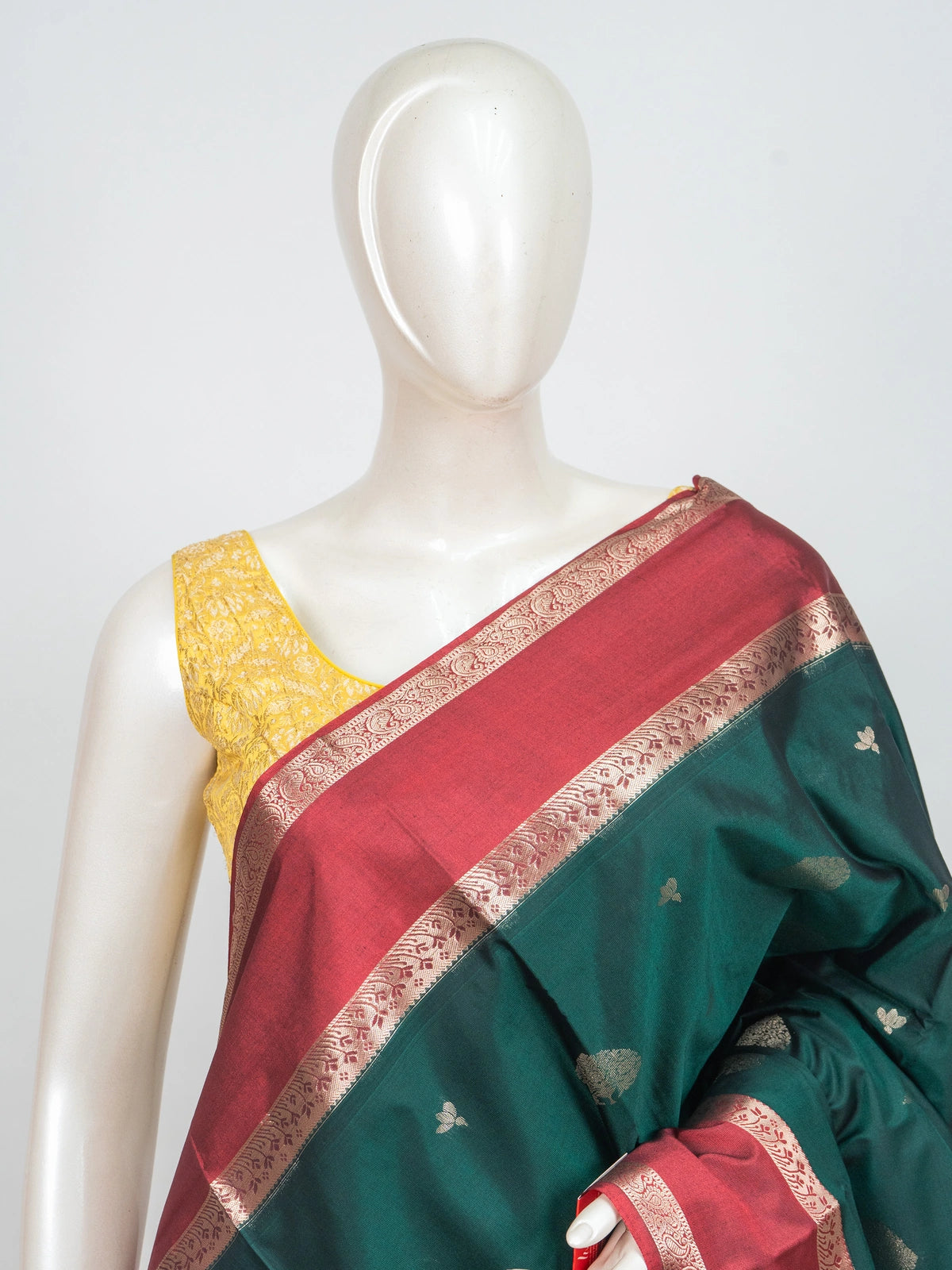 Bottle green semi silk saree with contrast maroon gold zari border and buttas
