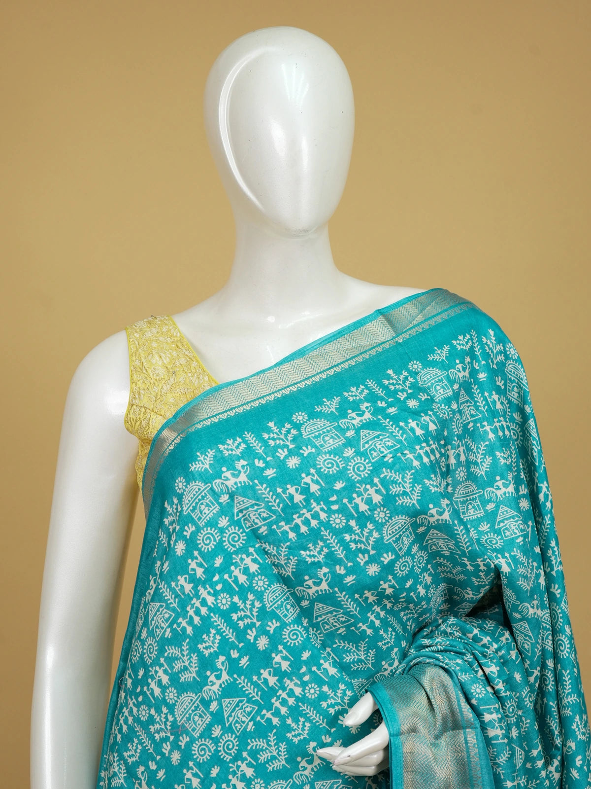 Teal blue designer saree with white Warli tribal print and gold zari border