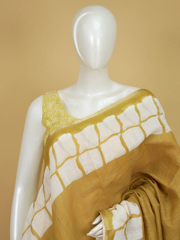 Mustard and white batik print linen cotton saree with contrast tile border and spiral motifs