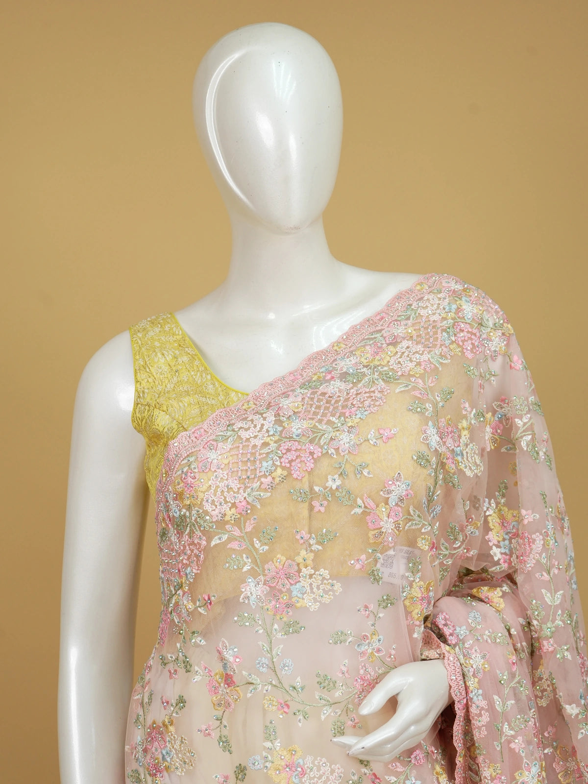 Soft pink net designer saree with pastel multicolour floral embroidery and scalloped border