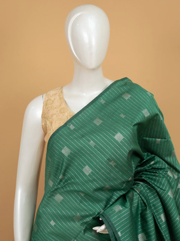 Green silk cotton saree with silver zari stripes and contrast magenta zari border and pallu