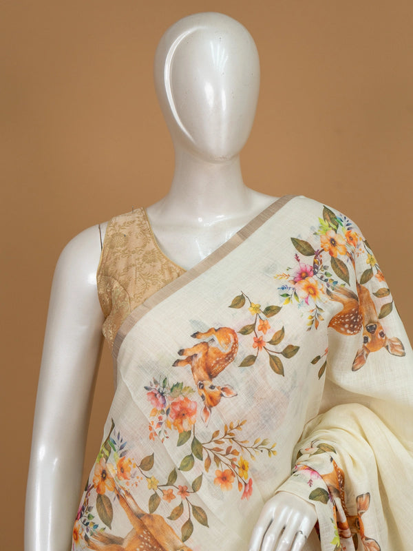 Cream linen cotton saree with orange floral and spotted deer prints and a slim golden zari border