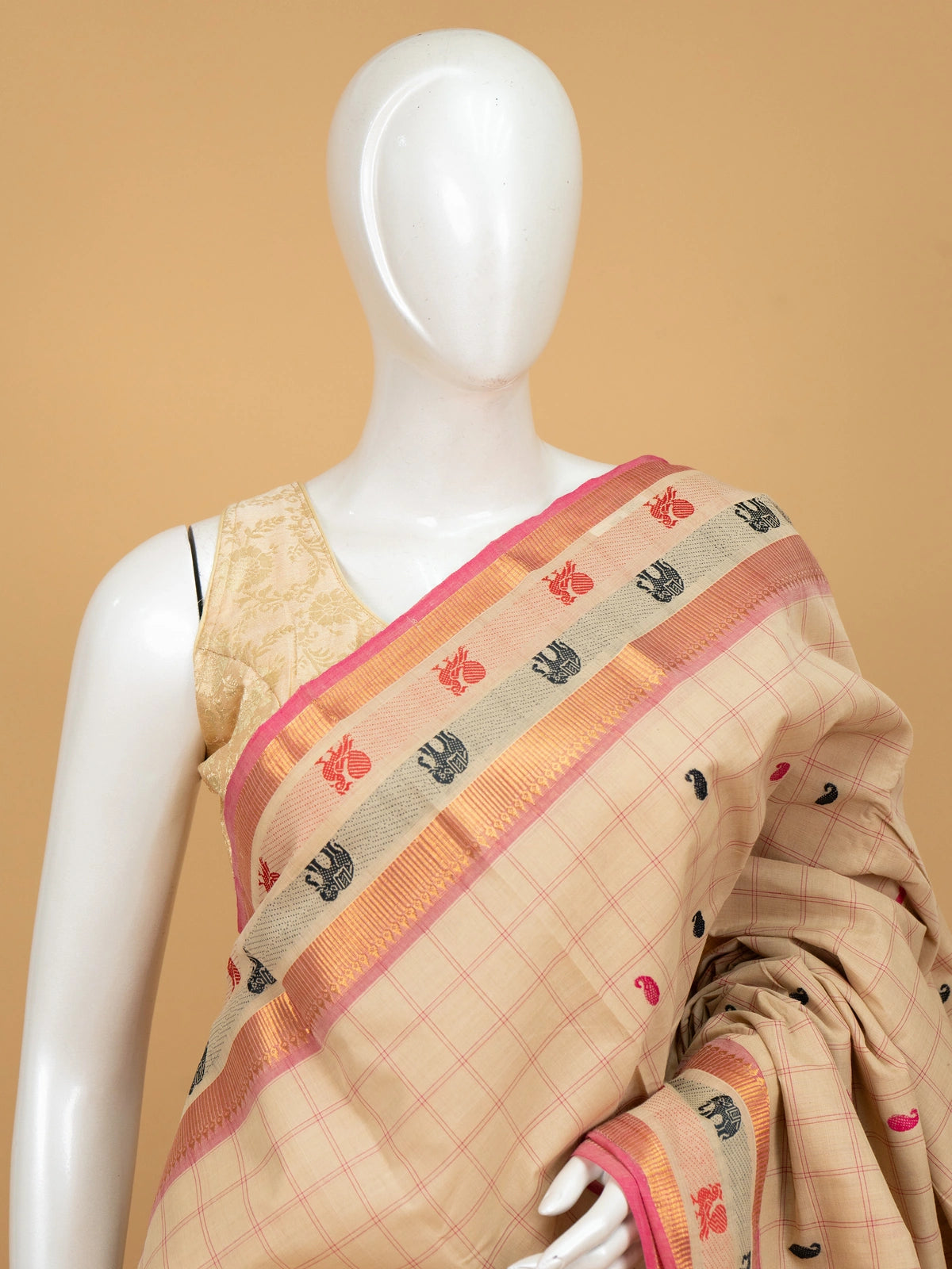 Beige and pink checked Chettinad cotton saree with gold zari border and paisley buttas