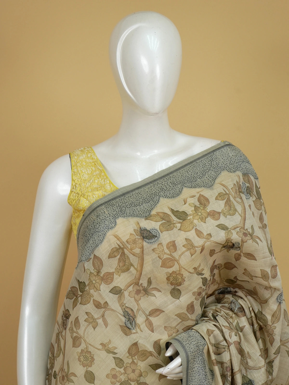 Beige linen cotton saree with kalamkari floral-bird print, grey-green contrast border and deer-motif pallu