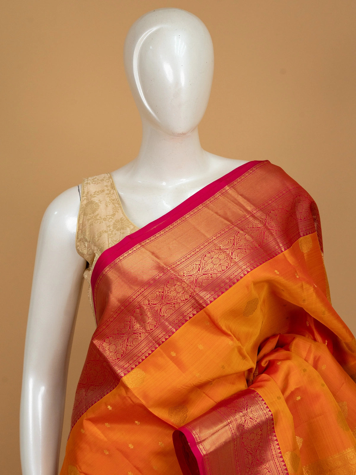 Orange and pink pure Kanchipuram silk saree with gold zari border and zari pallu