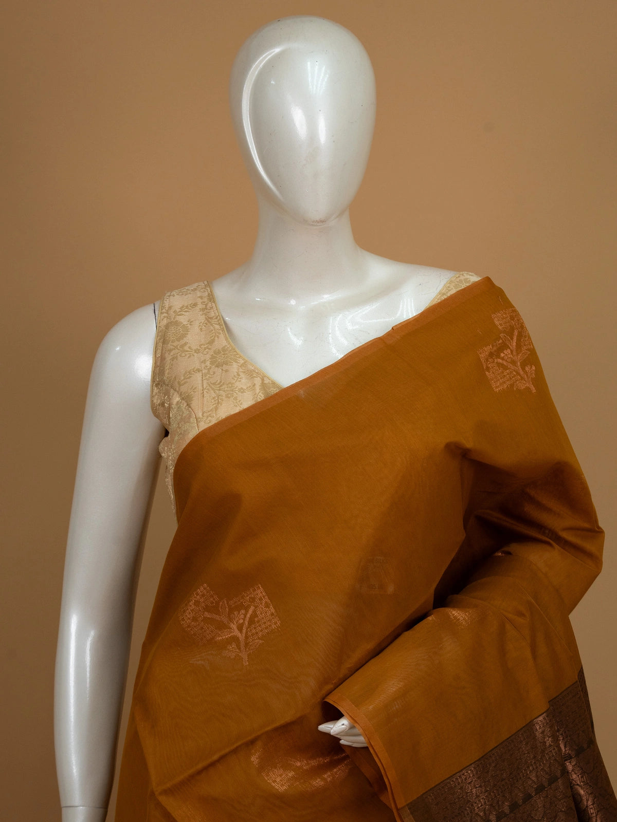 Mustard silk cotton saree with contrast dark brown copper zari border and woven buttas