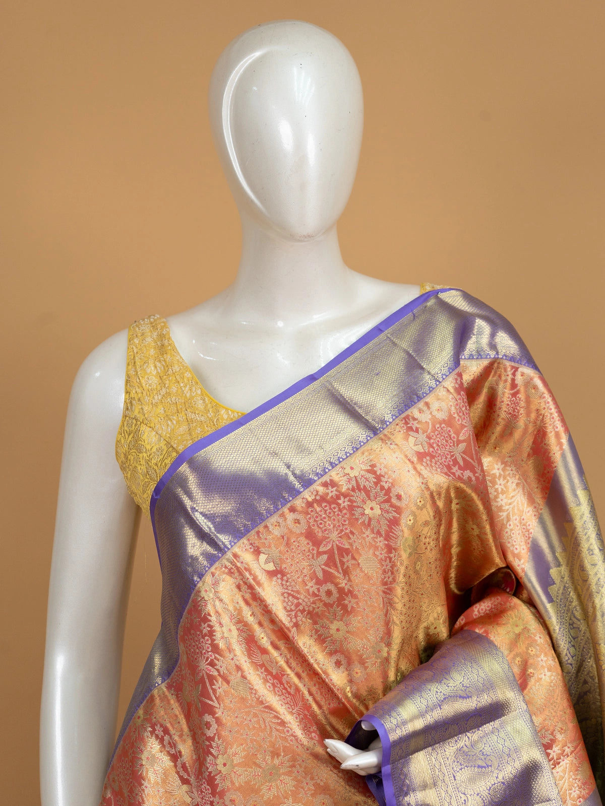 Peach orange pure Kanchipuram silk saree with floral gold zari body and contrast purple border