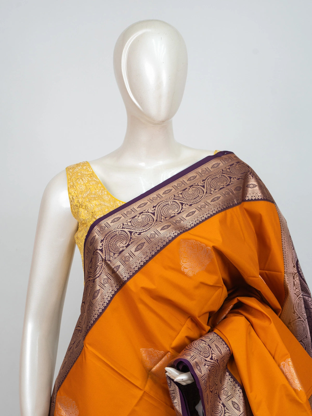 Mustard semi silk saree with contrast purple gold zari border, zari buttas, and ornate woven pallu
