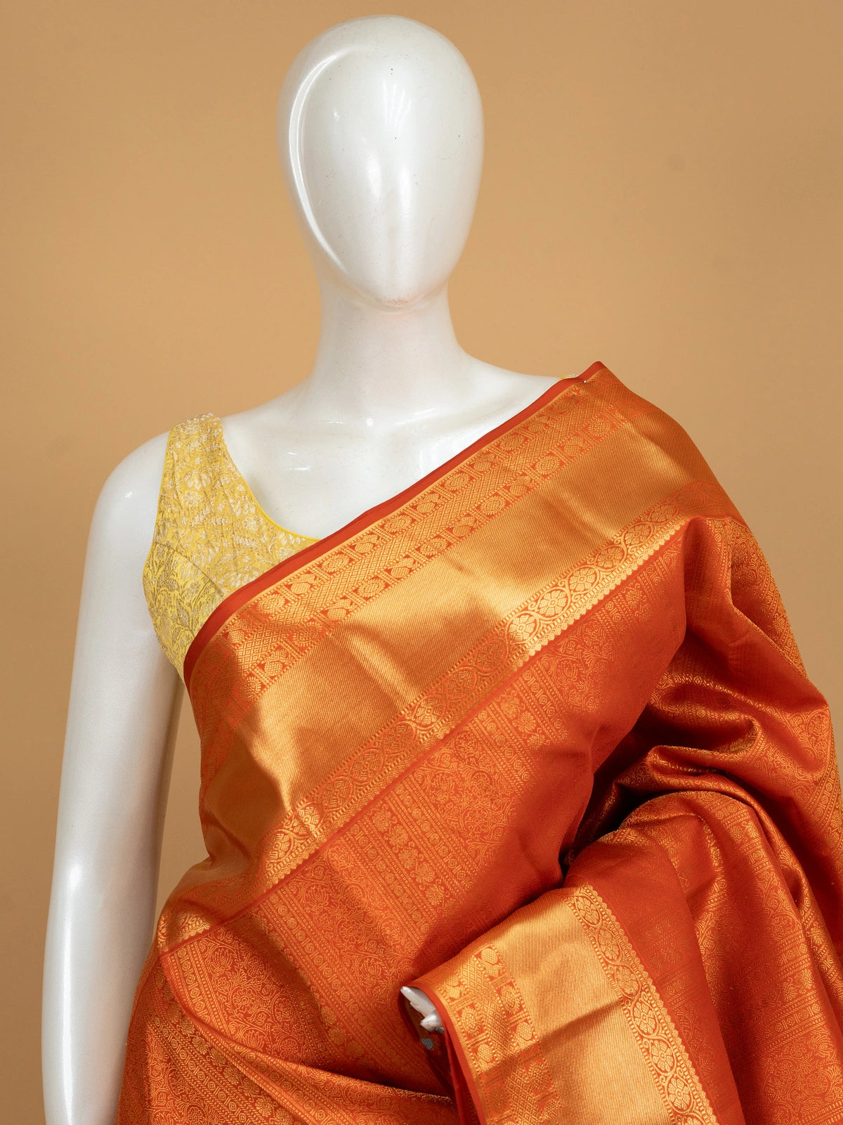 Orange pure Kanchipuram silk saree with allover gold zari brocade and wide gold zari border