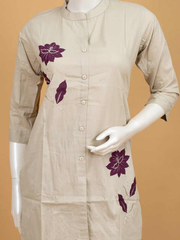 Beige cotton co-ord kurti set with purple floral appliqué motifs and matching straight pants