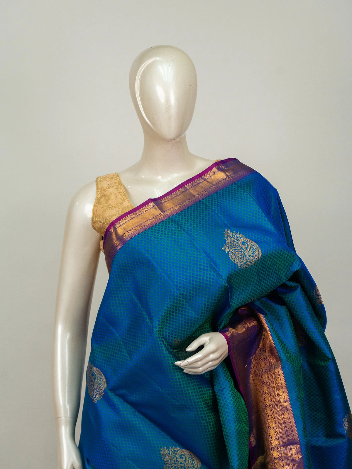 Peacock blue pure Kanchipuram silk saree with contrast purple gold zari border and paisley buttas