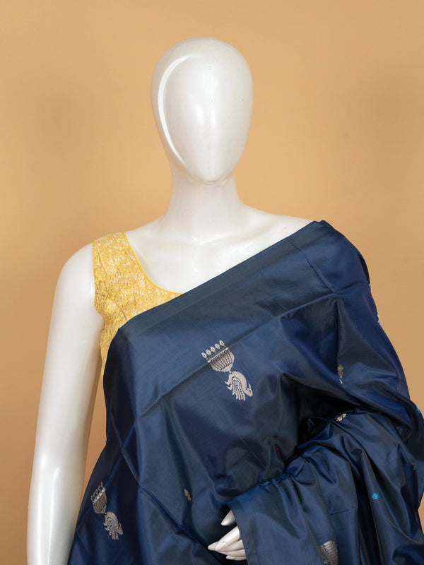 Navy blue banana silk saree with contrast peach pallu, peacock motifs and gold zari border