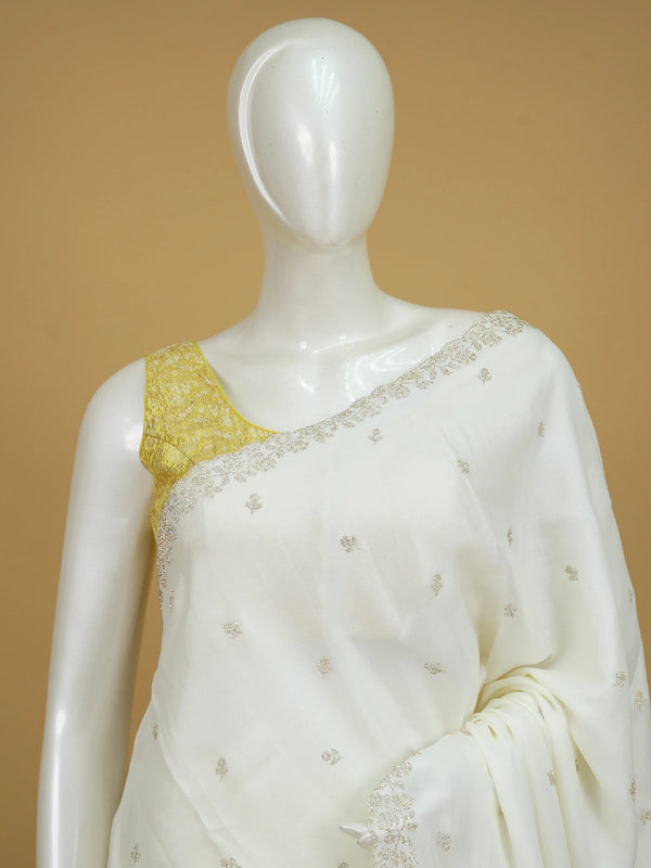 Off-white georgette designer saree with silver floral buttas and scalloped embellished border