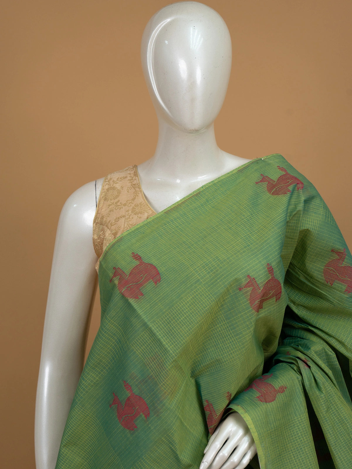 Green silk cotton saree with pink animal motifs and contrast blue-pink border