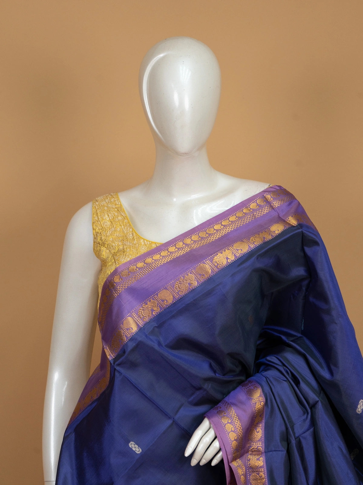 Navy blue banana silk saree with mauve-pink contrast pallu and gold zari peacock border