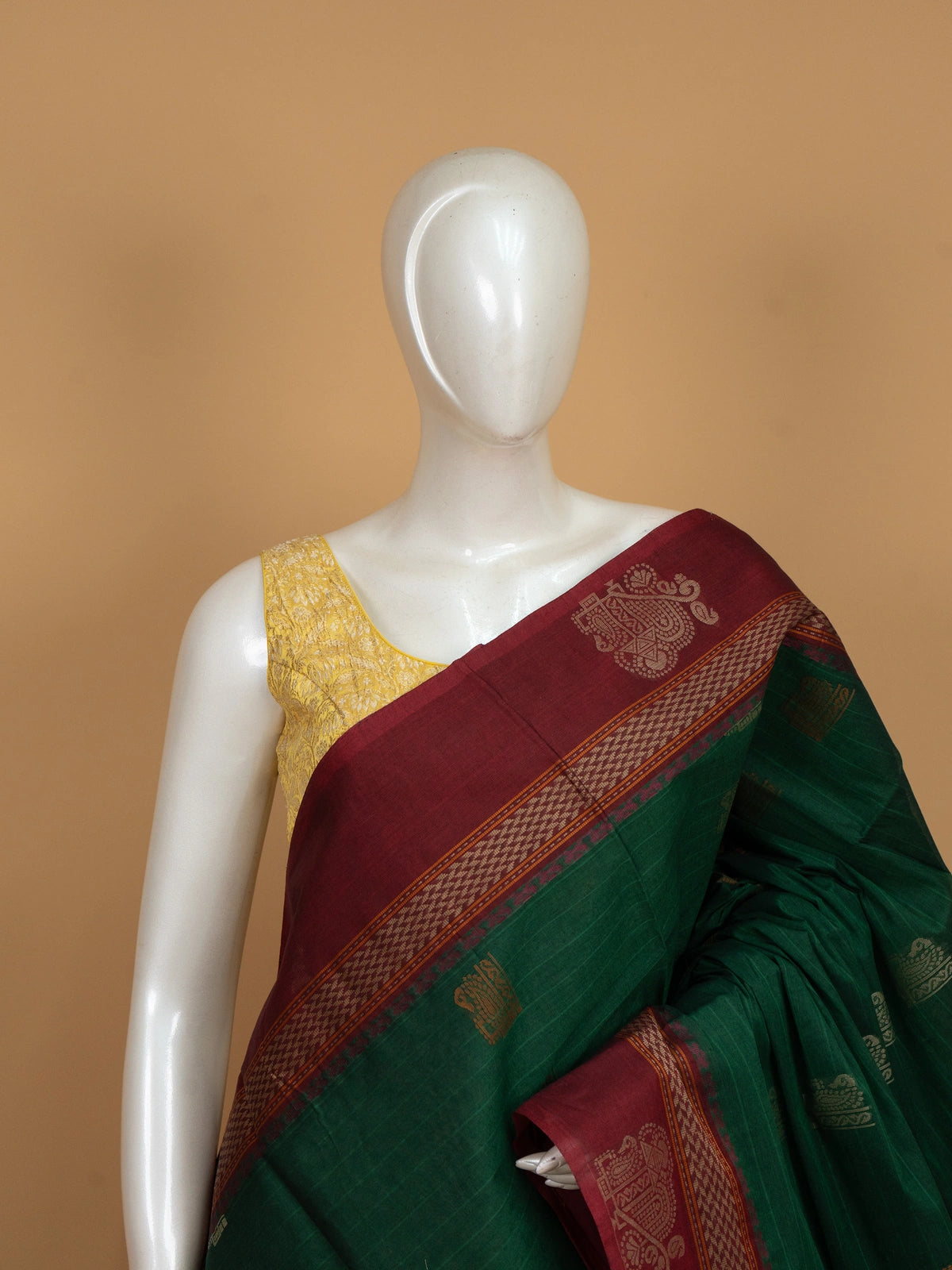 Green semi raw silk saree with contrast maroon zari border and woven pallu motifs