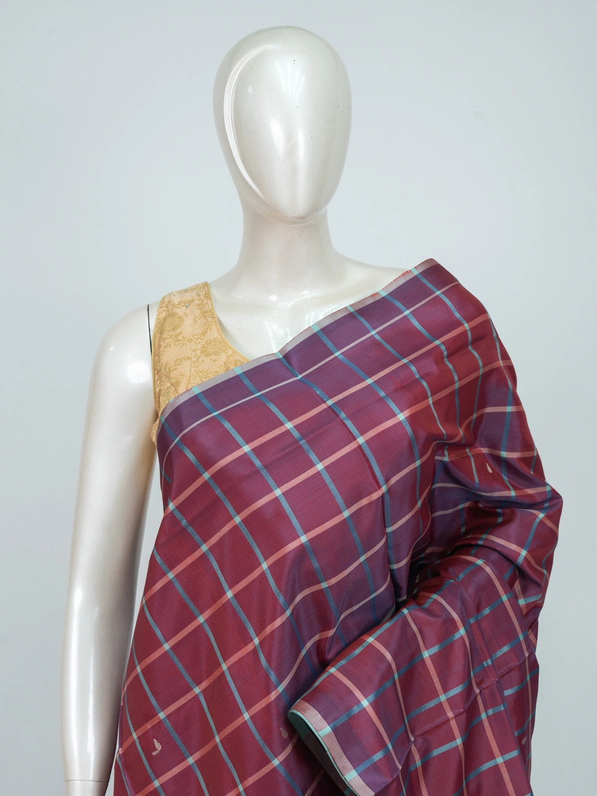 Wine maroon checked banana silk saree with contrast sea-green pallu, gold zari buttas and border