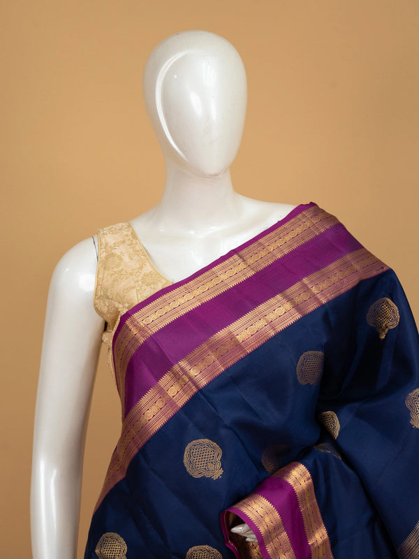 Navy blue pure Kanchipuram silk saree with magenta contrast border and gold zari buta motifs