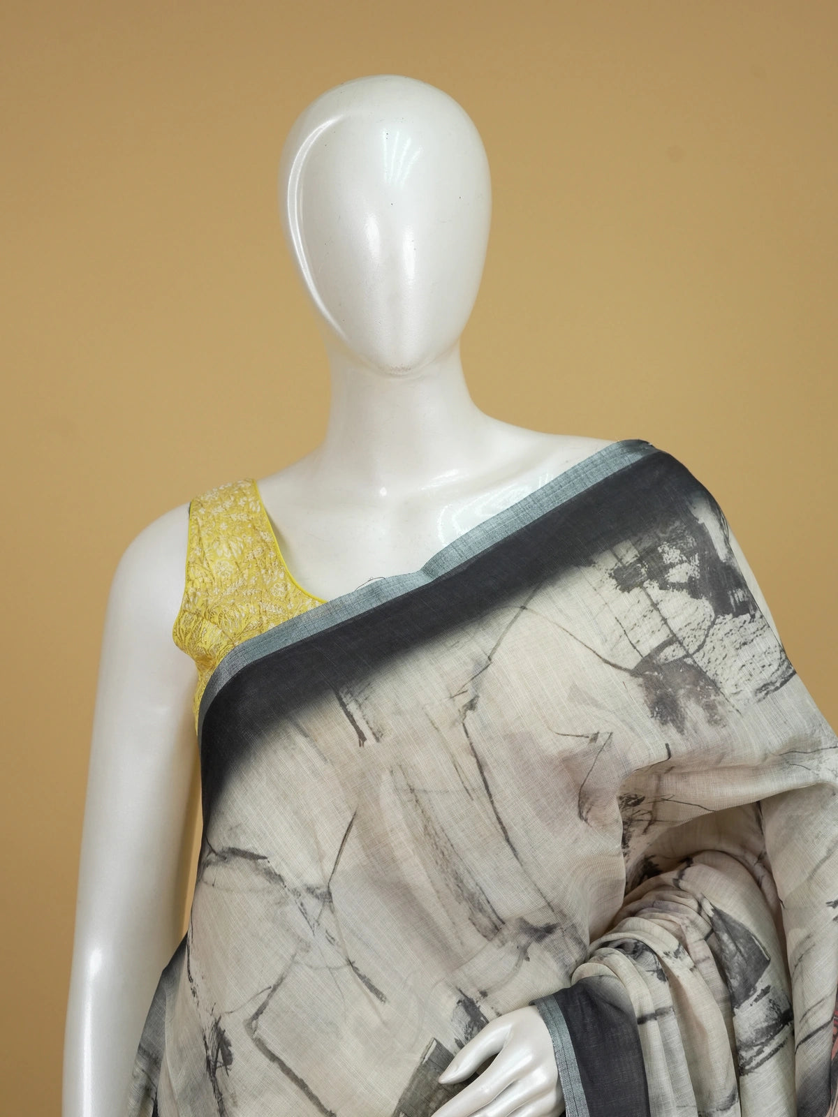 Cream and charcoal grey linen cotton saree with batik-style body print and Kalamkari peacock pallu