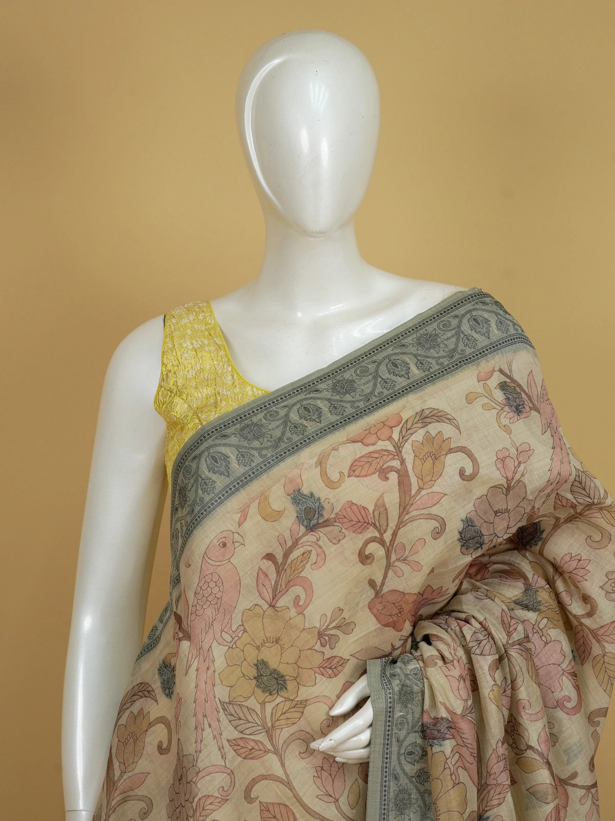 Beige linen cotton saree with Kalamkari floral print, parrot motifs and grey elephant pallu