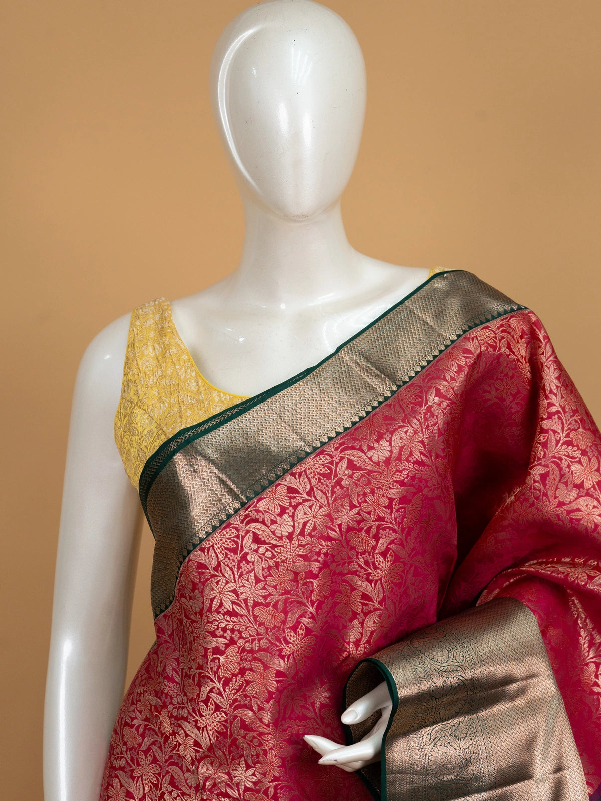 Rani pink pure Kanchipuram silk saree with green contrast border and gold zari floral jaal