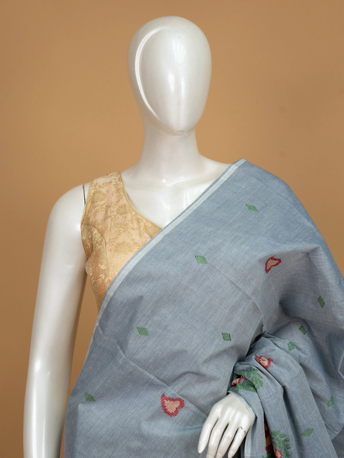 Grey linen cotton saree with red and cream floral buta motifs and striped pallu