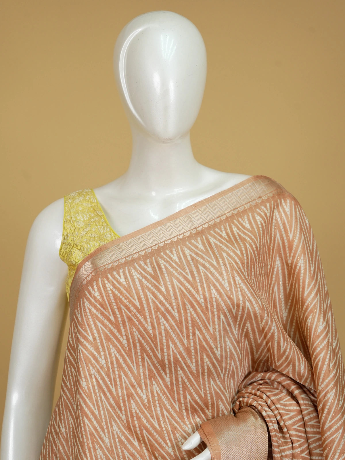 Peach and white designer saree with chevron print, gold zari border and tree-of-life pallu
