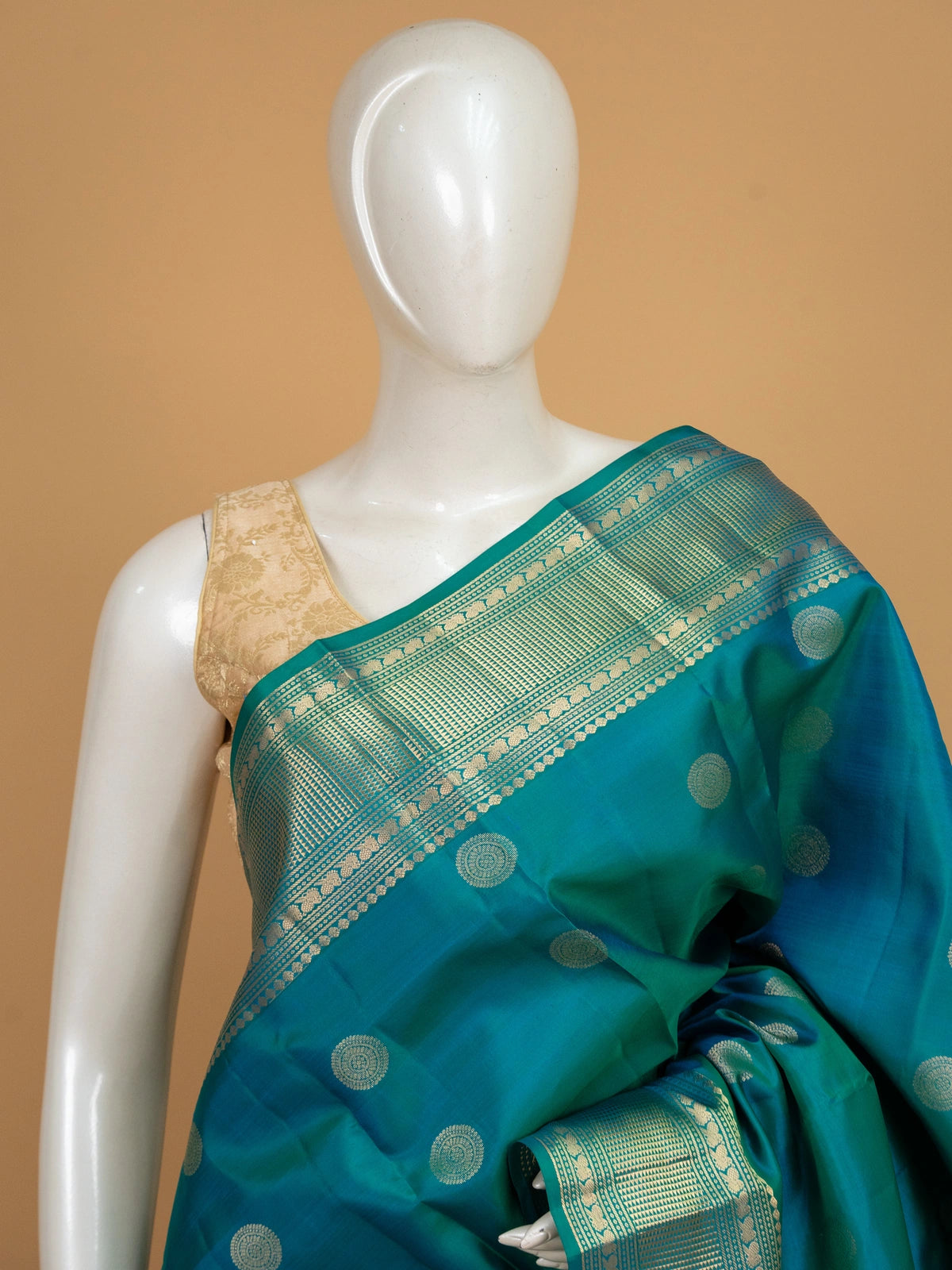 Peacock teal pure Kanchipuram silk saree with gold zari chakra buttas and contrast zari border