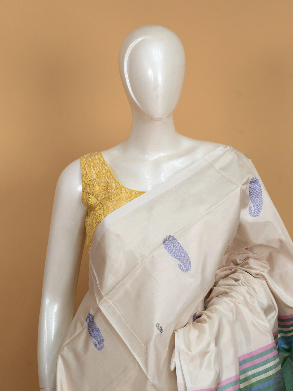 Cream banana silk saree with multicolour paisley buttas and contrast green striped pallu and border