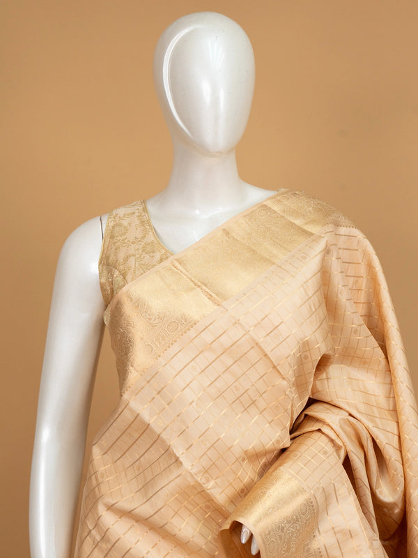 Cream and gold pure Kanchipuram silk saree with zari checks and paisley pallu