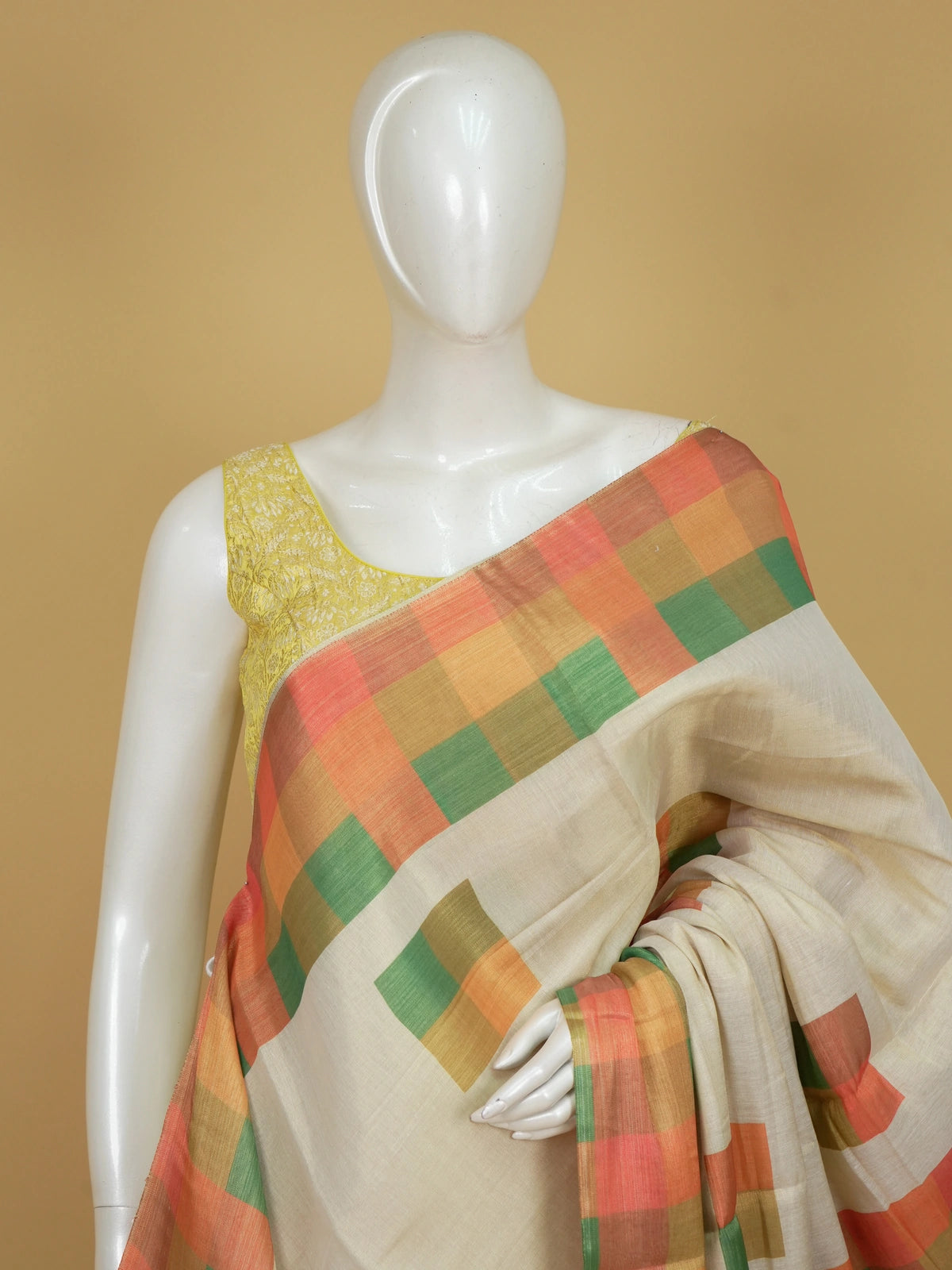 Cream linen cotton saree with multicoloured checked border, scattered square motifs and checked pallu