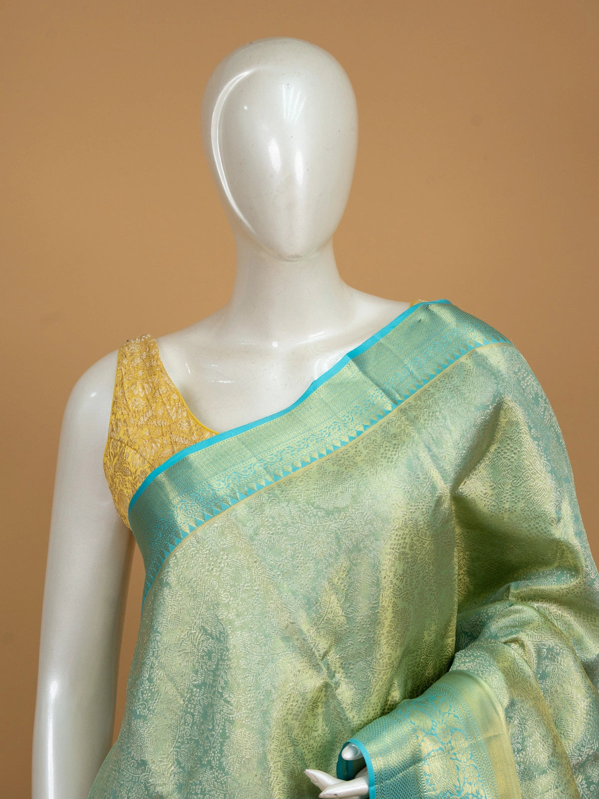 Pista green pure Kanchipuram silk saree with gold zari brocade body and turquoise blue contrast border