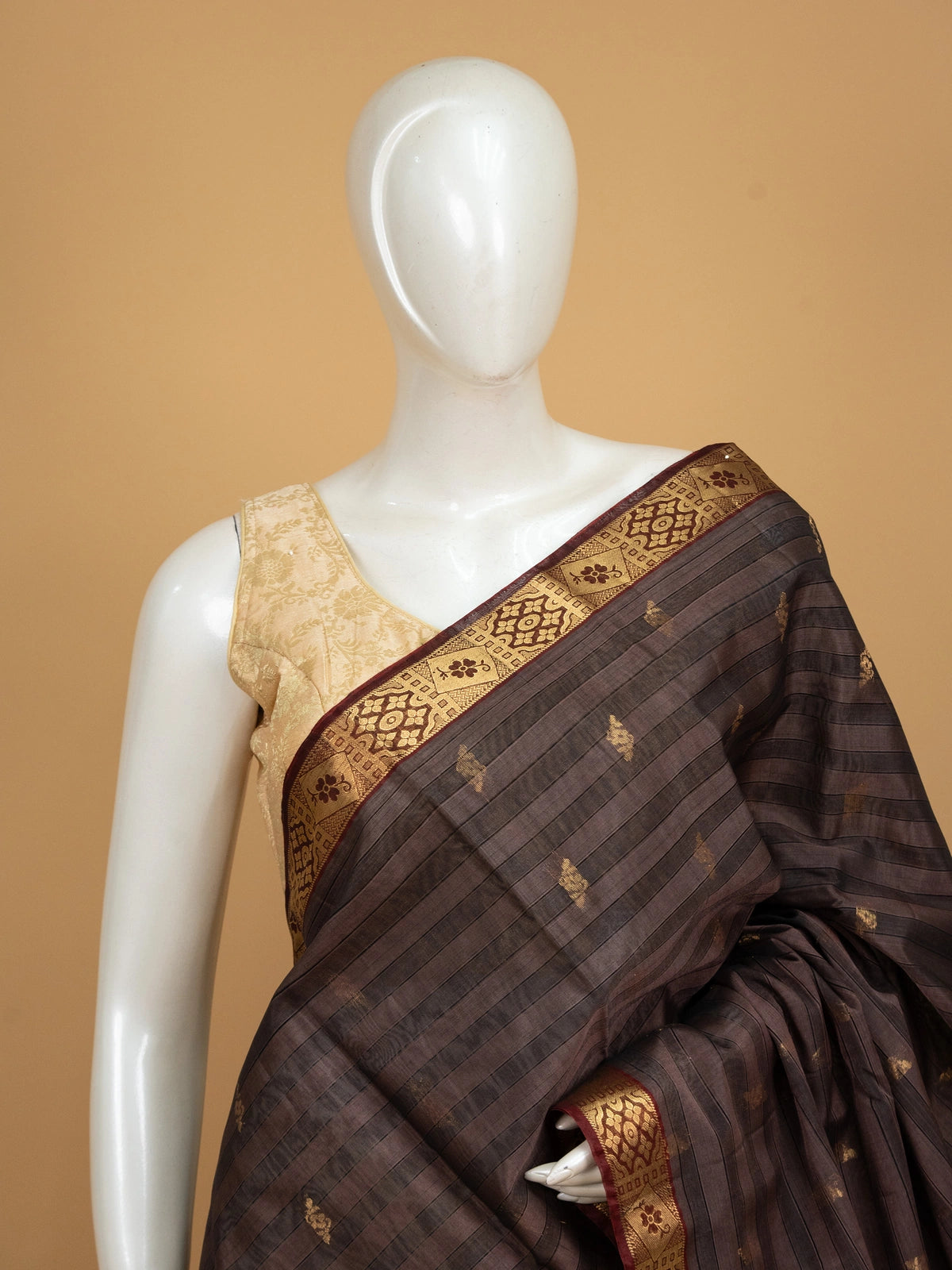 Coffee brown pure silk cotton saree with striped body, gold zari buttas, maroon contrast border and floral zari pallu