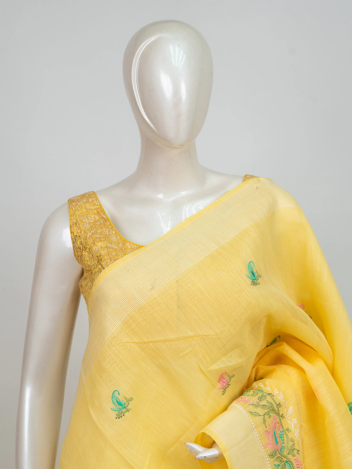 Yellow linen cotton saree with embroidered paisley buti motifs and gold zari border