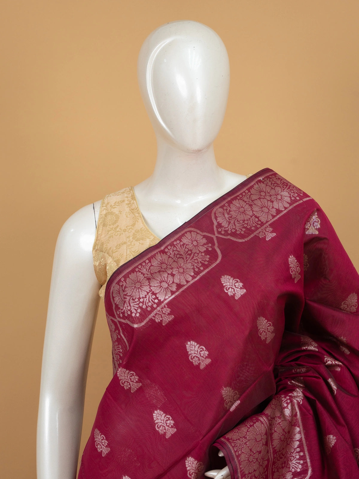 Magenta silk cotton saree with silver zari floral buttis and woven border