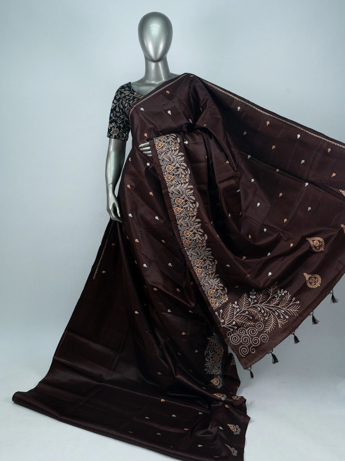 Dark chocolate brown semi raw silk saree with embroidered floral pallu and contrast black blouse