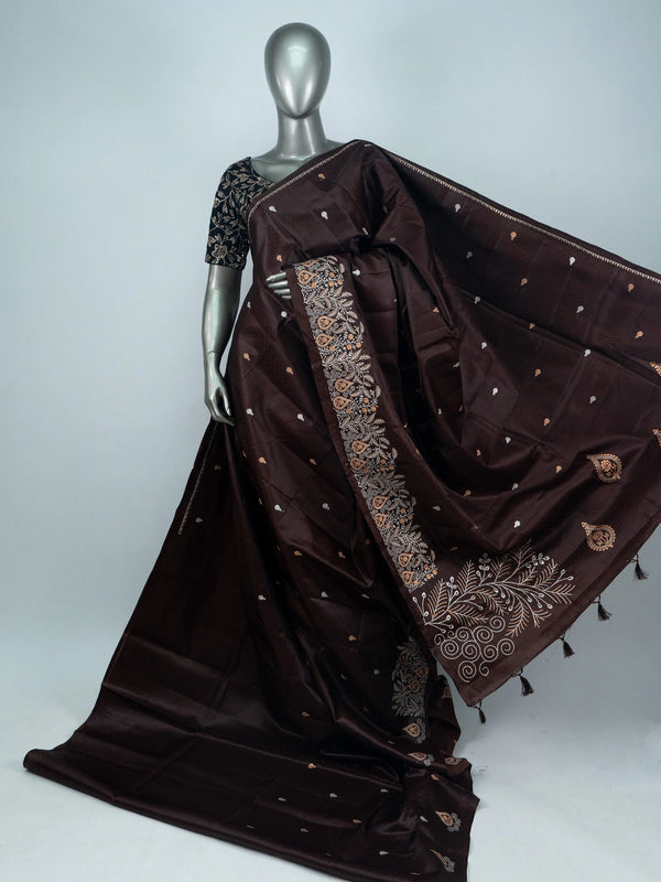 Dark chocolate brown semi raw silk saree with embroidered floral pallu and contrast black blouse