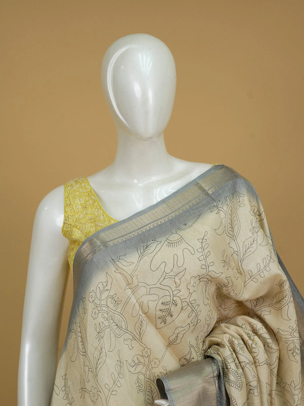 Beige Dola silk saree with Kalamkari peacock and floral motifs and contrast grey silver zari border