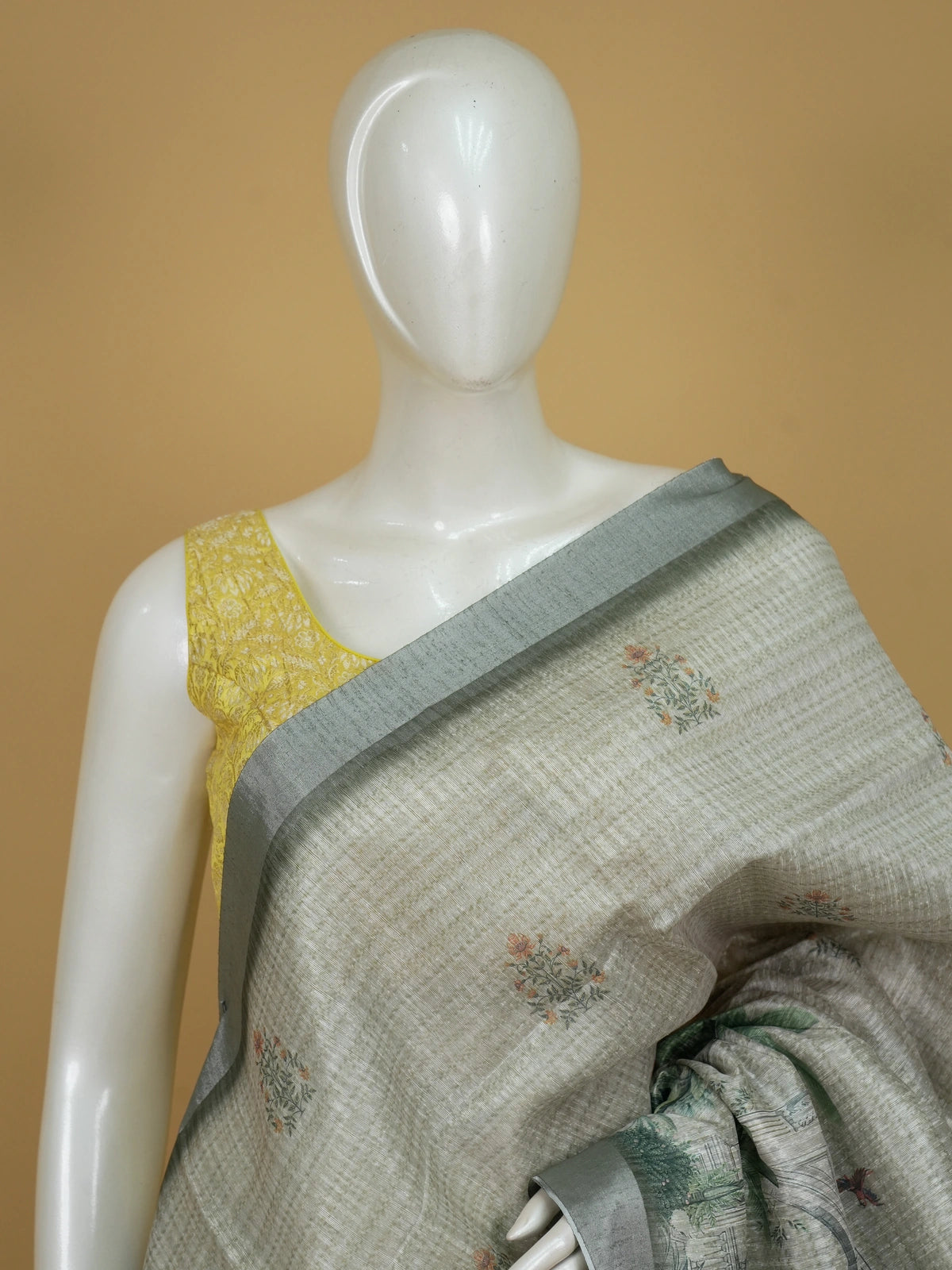 Grey and green semi tussar saree with floral buttas, silver-grey zari border and peacock scenic pallu