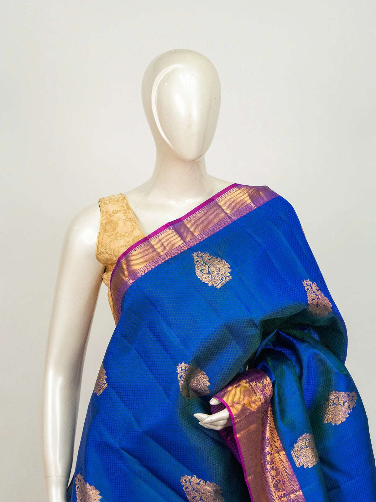 Royal blue Pure Kanchipuram silk saree with contrast magenta border, gold zari buttas and woven pallu