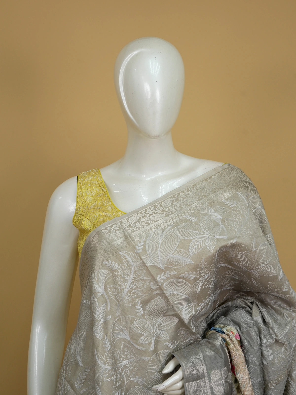 Grey designer saree with white floral embroidery, silver zari border and multicoloured embroidered roses